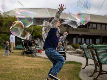 Edmonds Pier Child Playing in Giant Bubbles