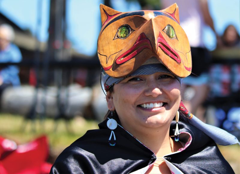 Female tribal member wearing wood headpiece