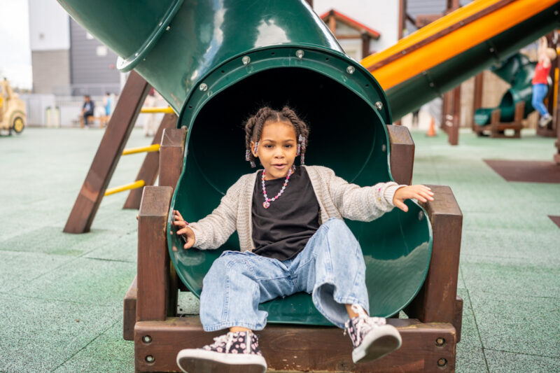 Girl enjoys a slide at Imagine Childrens Museum
