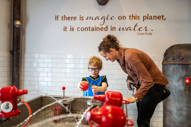 Little boy and mother learn the magic of water at Imagine Childrens Museum