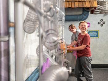 Little boy experiments with air movement at Imagine Chidrens Museum