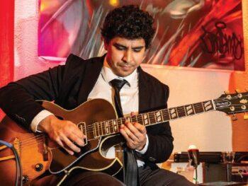 Performer Everett Philharmonic playing guitar at Apex Everett