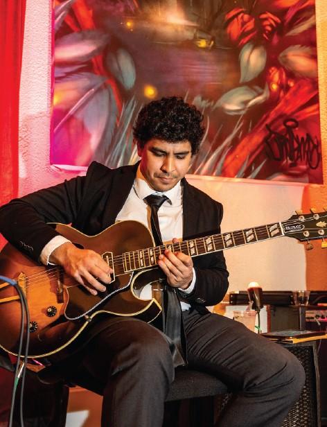 Performer Everett Philharmonic playing guitar at Apex Everett