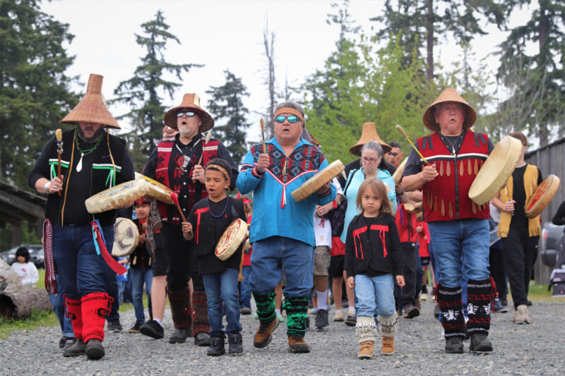 Tulalip Tribal Members march from longhouse to the shore of Tulalip Bay