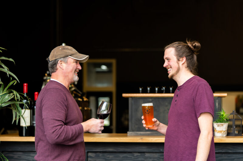 Winemaker enjoys a glass of wine with Beer brewer