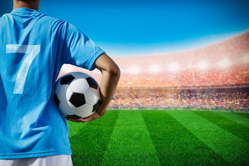 soccer football player no.7 in blue team concept holding soccer