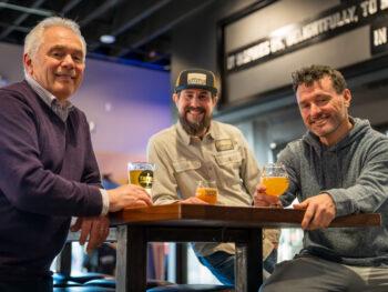 Tapped Millcreek 3 partners sitting at a table