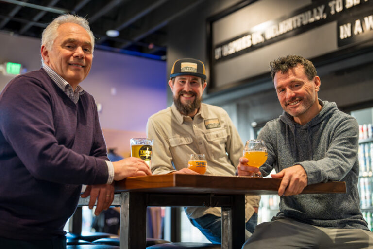 Tapped Millcreek 3 partners sitting at a table