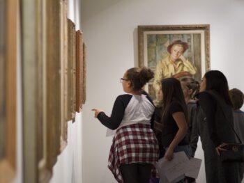 School tour group discuss about art