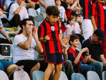 Soccer fans viewing game from stands
