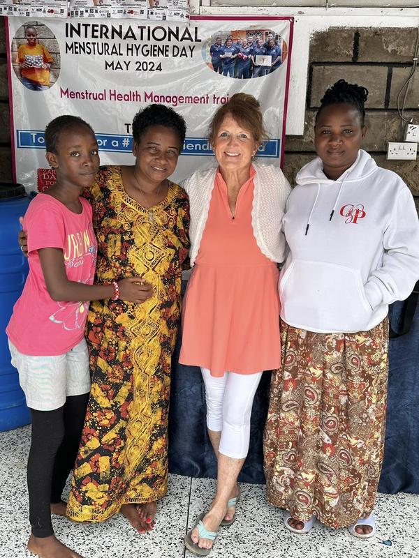 Tonya Christofferson posing with women she has taught to sew