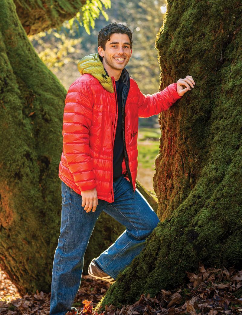 Paul Rothrock leaning against tree in the park.